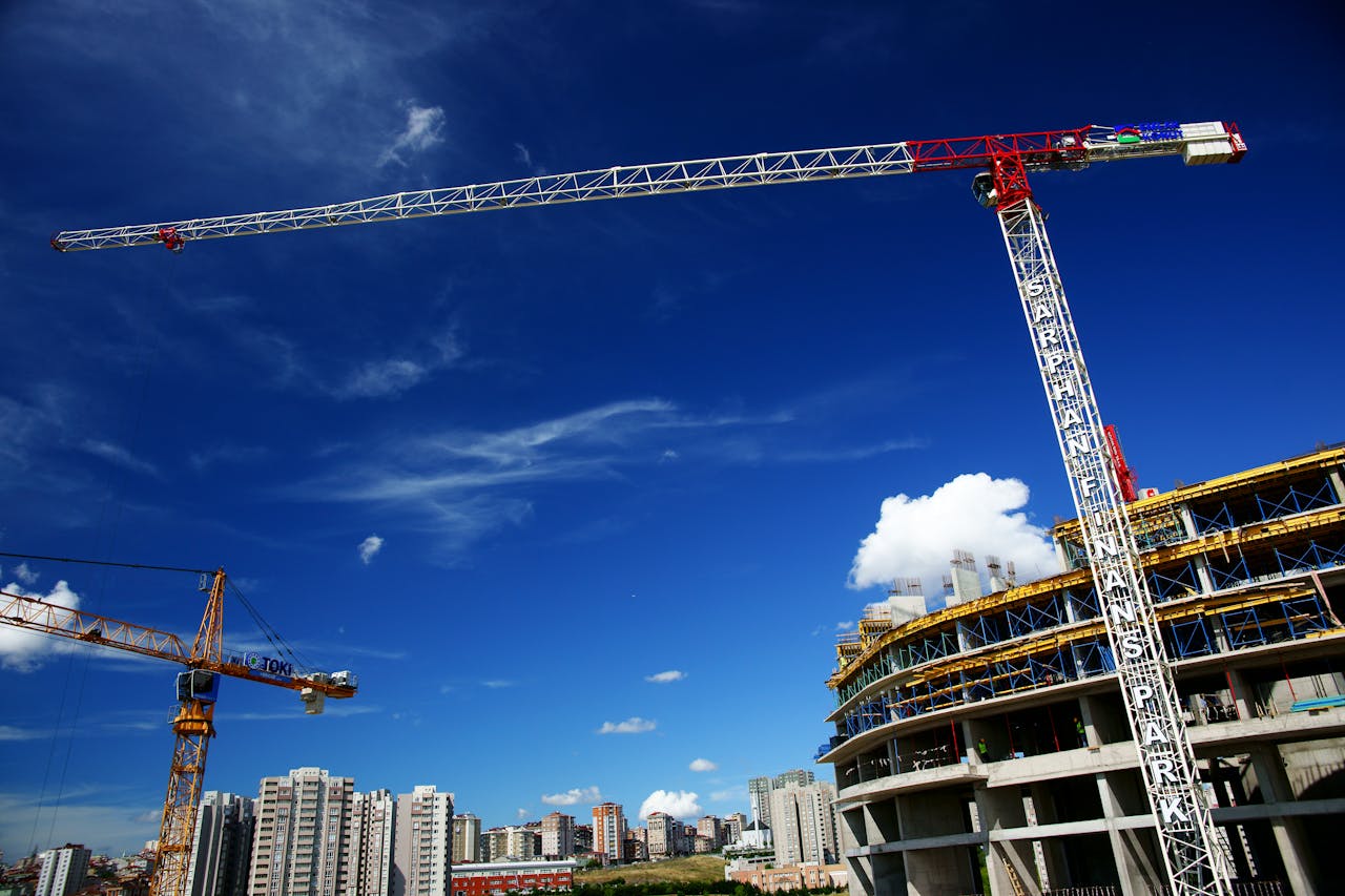 Services Tower cranes towering over a city skyline, showcasing ongoing urban construction.